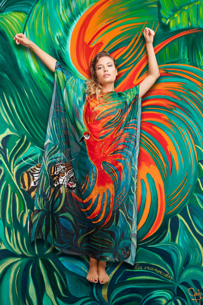Tiger and Bird luxury kaftan with hand-embroideries magnified by model Dana posing in front of the original painting in background